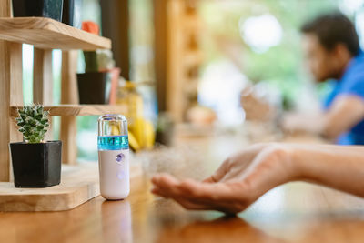 Close-up of hand on table at home