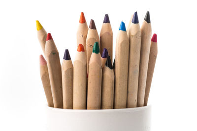 Close-up of colored pencils against white background