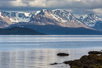 Scenic view of snowcapped mountain against cloudy sky