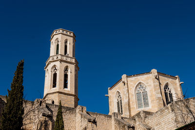 Low angle view of historic building against clear blue sky