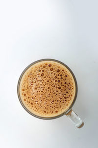 High angle view of coffee cup against white background