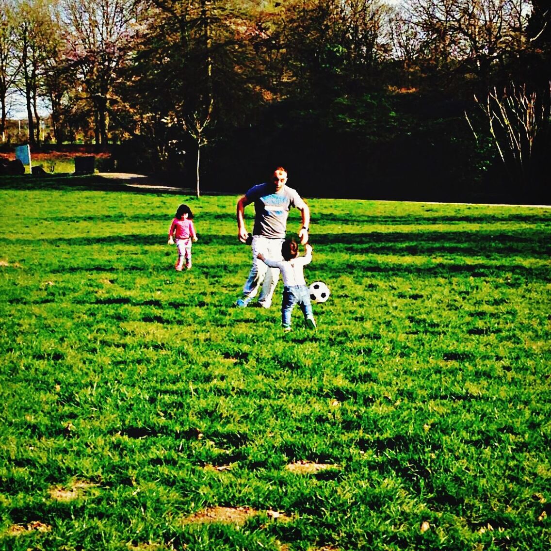 grass, green color, tree, park - man made space, field, grassy, leisure activity, childhood, playing, lifestyles, lawn, full length, park, sport, girls, boys, playful, grassland