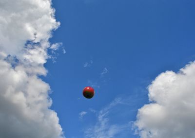 Low angle view of balloons against blue sky