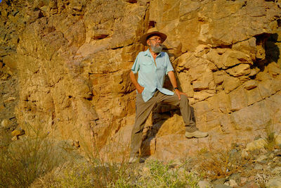 Rear view of woman standing on rock