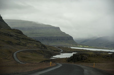 Empty road along countryside landscape