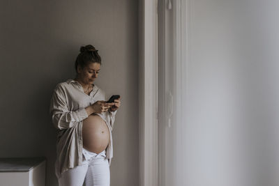 Pregnant woman using cell phone