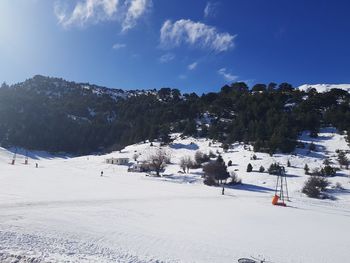 Scenic view of snow covered land against sky