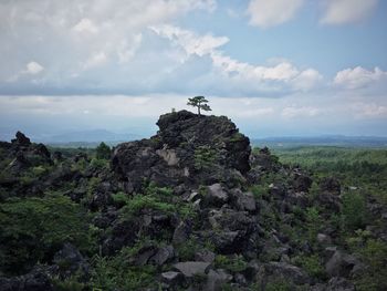 Scenic view of mountains against cloudy sky