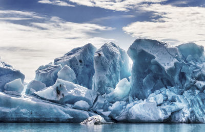 Glaciers in sea against the sky