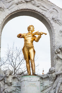 Low angle view of angel statue against building