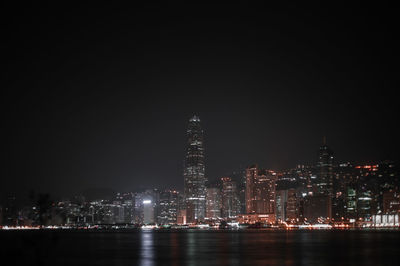 Illuminated buildings against sky at night