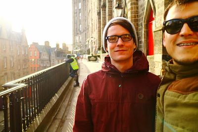 Portrait of smiling young couple standing in city