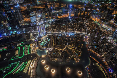 High angle view of illuminated buildings in city at night