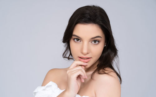 Portrait of a beautiful young woman over white background