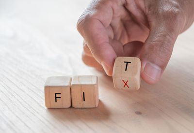 Close-up of hand holding toy on table