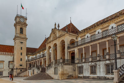 Facade of historic coimbra university building against sky