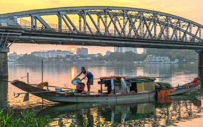 People on bridge over river