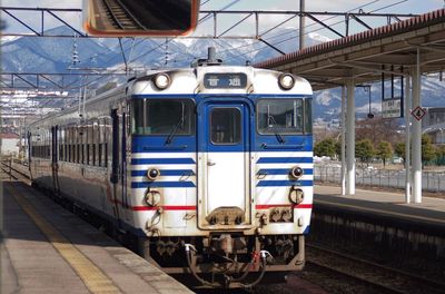 Train at railroad station against sky