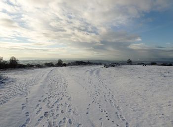 Snow covered land against sky