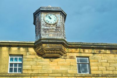 Low angle view of clock tower against sky