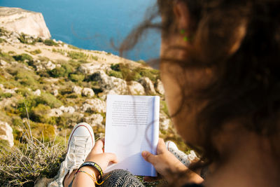 High angle view of woman reading book