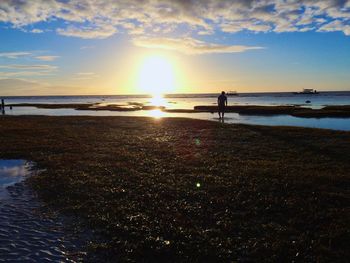 Scenic view of beach against sky during sunset