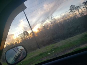 Scenic view of sunset seen through car window