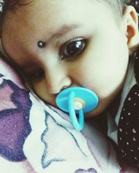 Close-up portrait of cute baby on bed