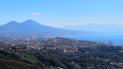 High angle view of cityscape by sea against sky