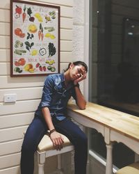 Portrait of tired man sitting at table