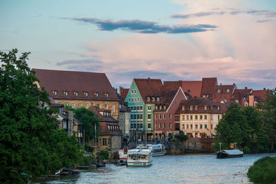 Boats in river with buildings in background