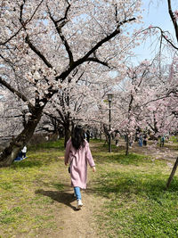 Rear view of woman standing on field
