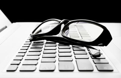 Close-up of eyeglasses on laptop