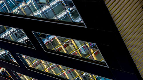 Low angle view of building seen through glass window