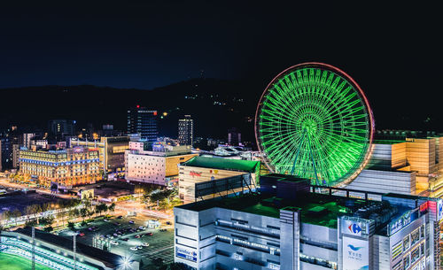 High angle view of illuminated ferris wheel at night