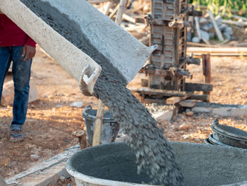 Low section of man standing at construction site