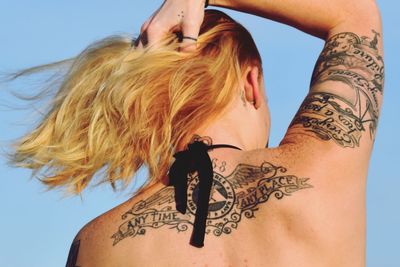 Rear view of woman with tattoo on back