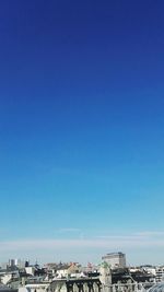 View of cityscape against blue sky