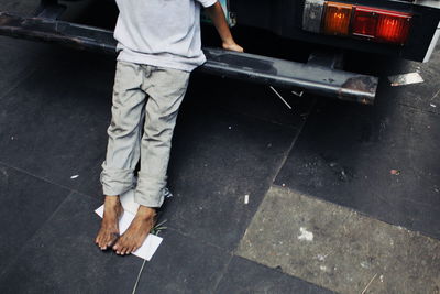 Low section of man standing on street