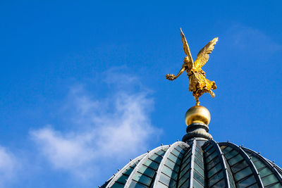 Low angle view of statue against blue sky