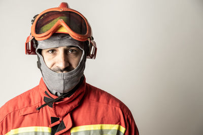 Portrait of man wearing mask against gray background