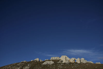 Low angle view of rock formation against sky