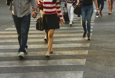 Low section of people walking on street