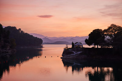 Scenic view of lake against orange sky