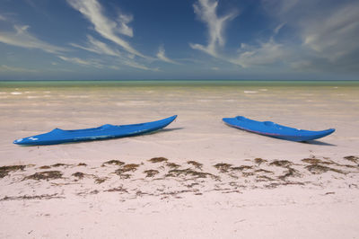 Two kaiaks on a deserted tropical beach on holbox island in mexico.