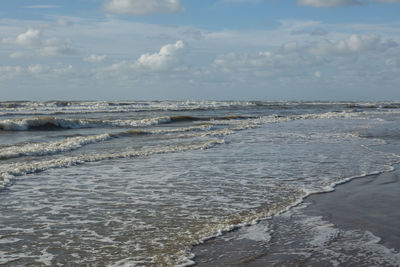 View of calm sea against cloudy sky