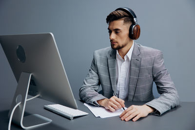 Young man using laptop at office