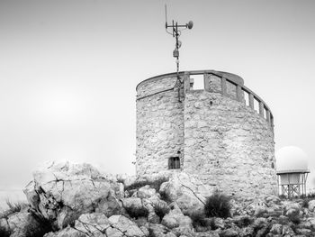 Low angle view of old tower against clear sky