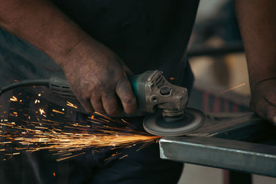 Midsection of man working in workshop