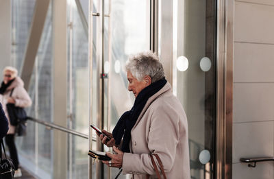 Senior holding cell phone